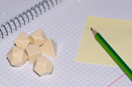 open exercise book with sticky card, pencil and blank rpg dices - stock photoの写真素材