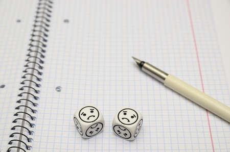 open exercise book with mood dice (sad) - stock photoの写真素材