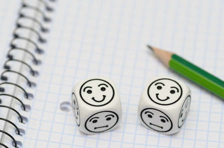 open exercise book with pencil and mood dices showing happy face - stock photoの写真素材