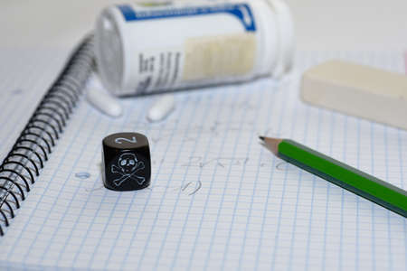 study place with painkillers in background and skull dice - stock photo