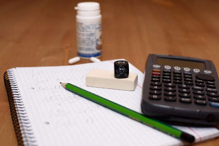 study place with calculator and painkillers in backgroundの写真素材