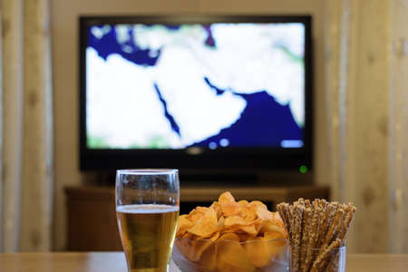 TV, television watching (map of near east, news) with snacks lying on the table - stock photoの写真素材