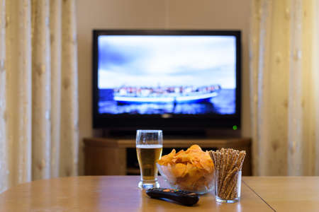 TV, television watching (refugee boat, news) with snacks - stock photoの写真素材