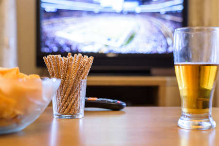 TV, television watching (American football match) on TV with snacks and alcohol - stock photoの写真素材