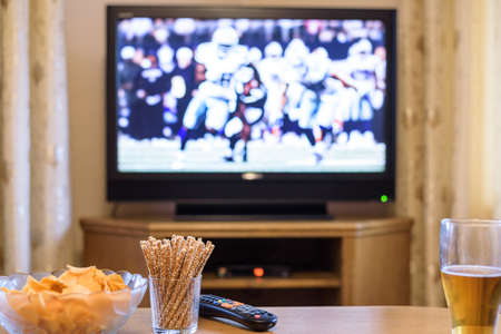 TV, television watching (American football match) on TV with snacks and alcohol - stock photoの写真素材