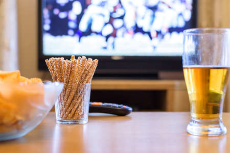 TV, television watching (American football match) on TV with snacks and alcohol - stock photoの写真素材