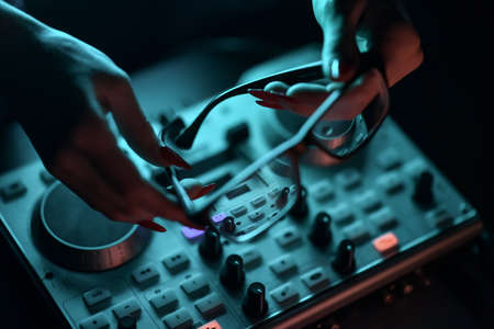 DJ mixer disco illuminated by searchlightsの写真素材