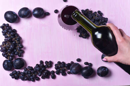 composition of wine, grape and plumsの写真素材