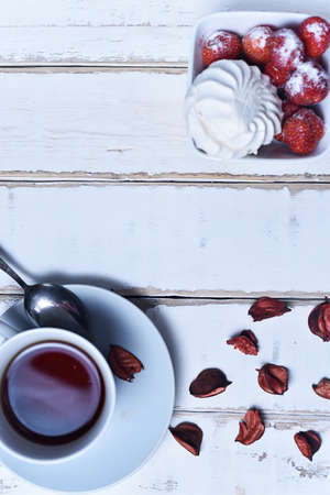 Tea and strawberries with marshmallowsの写真素材