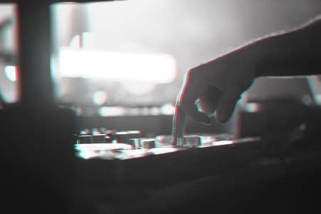 DJ mixer disco illuminated by searchlightsの写真素材