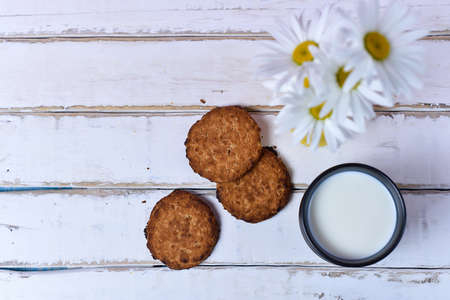 Chamomile and milk with cookiesの写真素材