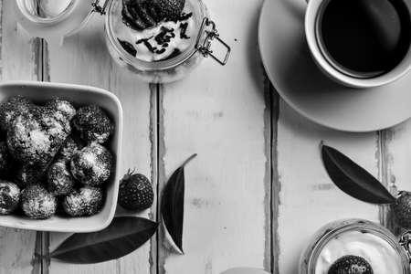 Strawberry cheesecake dessert in a jar on the table black and white posterの写真素材
