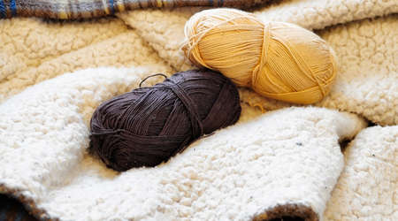 Yarn and knitting needles on the table in the room