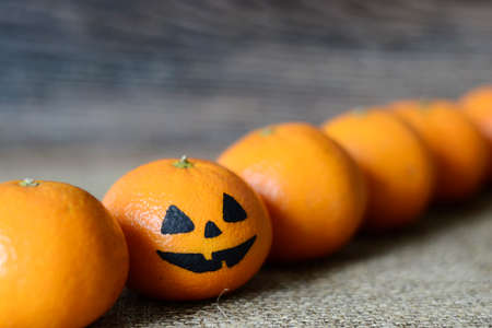 Painted scary faces on a holiday of halloween on orangeの写真素材