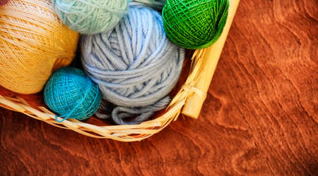 Yarn and knitting needles on the table in the room