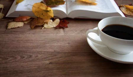 Objects on a wooden table a cup of coffeeの写真素材