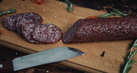 Smoked sausage on a wooden board