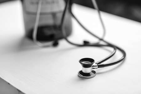 Stethoscope on a table in a doctor's office black and white poster