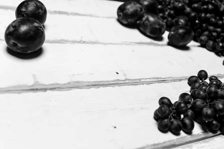 Prunes and grapes on the table black and white posterの写真素材