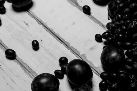 Prunes and grapes on the table black and white posterの写真素材