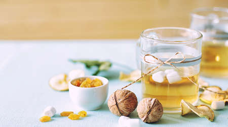 Dried fruits compote. Glass cups with drink from dried fruits, apples, meats, raisins with sugar. A...