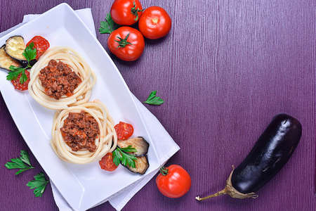 Italian pasta with meat on a plate in a cafeの写真素材