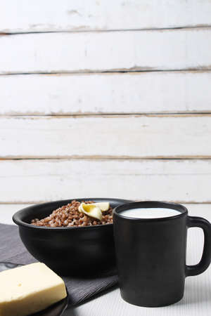 buckwheat porridge on a wooden table in the dishの写真素材