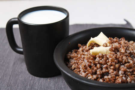 buckwheat porridge on a wooden table in the dishの写真素材