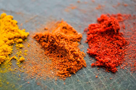 Eastern condiments scattered on a table at home. Turmeric and peの写真素材
