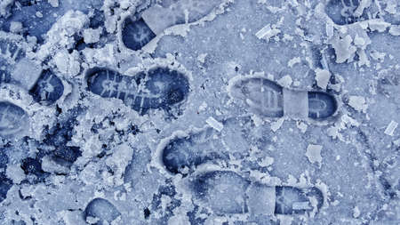 Dirty footprints in the snow winter. Track from boots on the traの写真素材