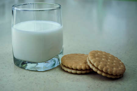 Cookies and milk on the kitchen table.の写真素材
