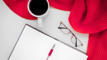 Knitted scarf and hat on the table.の写真素材