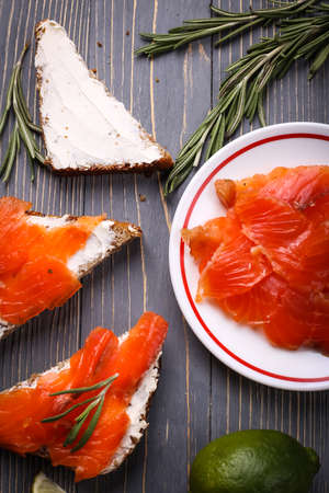 Sandwich of bread and salmon on the tableの写真素材