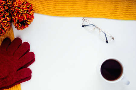 Knitted scarf and hat on the table.の写真素材