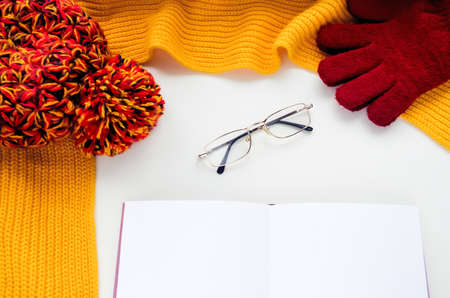 Knitted scarf and hat on the table.の写真素材