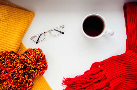 Knitted scarf and hat on the table.の写真素材