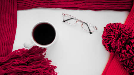 Knitted scarf and hat on the table.の写真素材