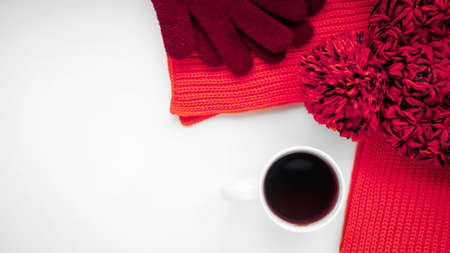 Knitted scarf and hat on the table. Warm clothes for fall and wiの写真素材