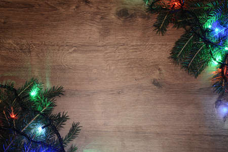 New-year electric garland on a wooden background. Bright bulbs oの写真素材