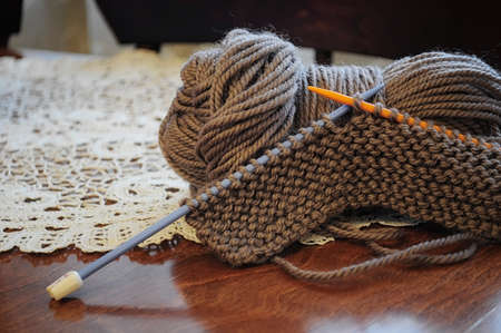 Clumps of yarn and knitting needles on the table