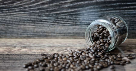 Coffee beans on a wooden backgroundの写真素材