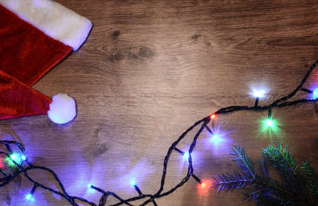 New-year electric garland on a wooden background. Bright bulbs oの写真素材