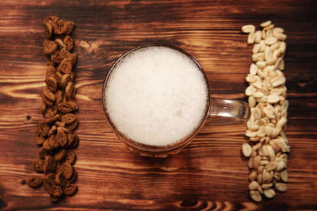 Beer light in a mug and snack