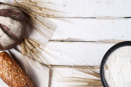 Fresh baked bread with ears of wheat. Wheat yellow. Breakfast isの写真素材