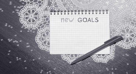 Notepad for entries on the table. Handle and paper on a wooden sの写真素材