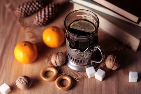 Old books and tea in the evening. A glass of drink on table. Theの写真素材