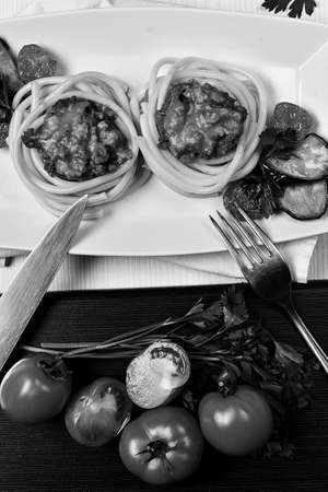 Dinner in the restaurant. Hands plates of food. Fork for eating.の写真素材