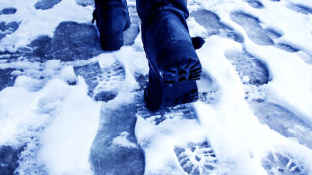 Dirty footprints in the snow in the winter. の写真素材