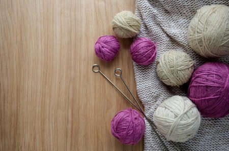 Balls of woolen yarn for knitting on the table. の写真素材