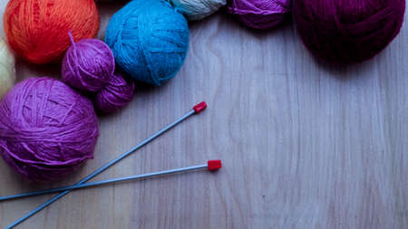 Balls of woolen yarn for knitting on the table. の写真素材